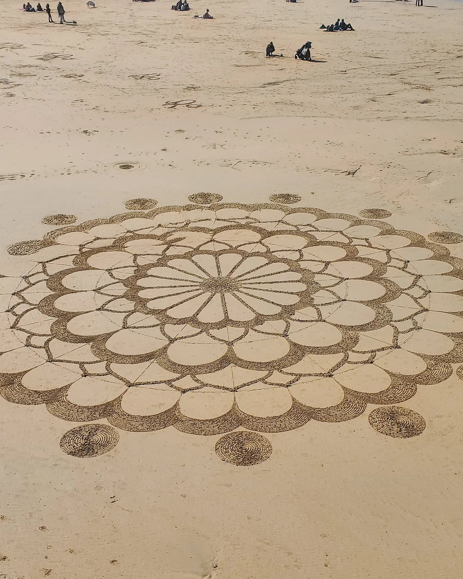 Sacred geometry mandala drawn in sand representing future life progression and conscious creation.